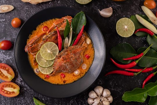 Tom yum crab with lemon, chili, tomato, garlic, lemongrass, kaffir lime leaves in a plate