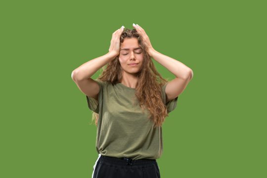 Portrait of young teen girl with headache