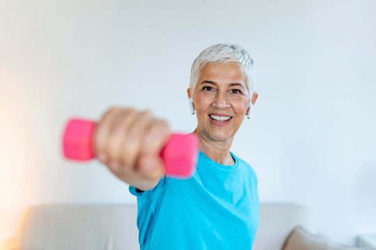 Senior woman exercise with dumbbells at home elderly woman prefers healthy lifestyle