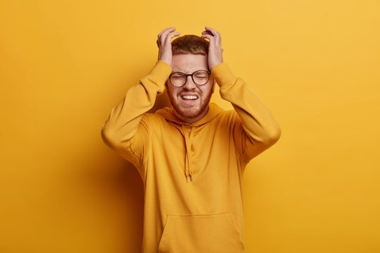 Close up on bearded young man wearing glasses isolated