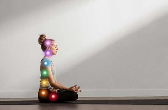 Woman maintaining asana while chakra points are aligned