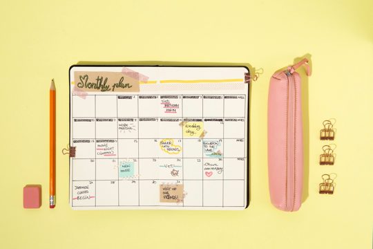 Bullet journal and supplies arrangement above view