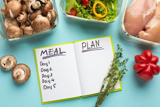Top view arrangement with meal planning notebook