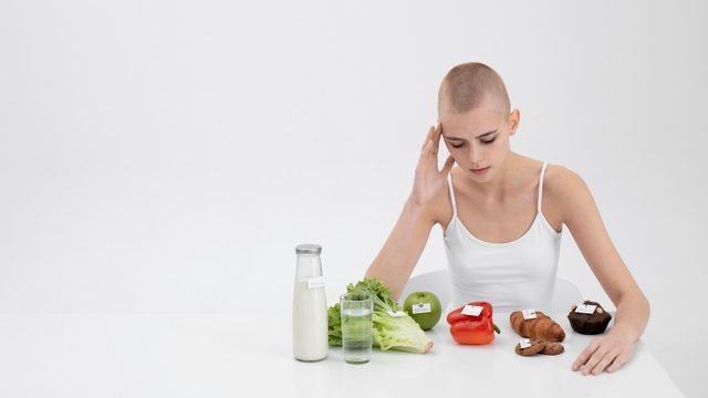 Young woman with an eating disorder next to food with calories numbers