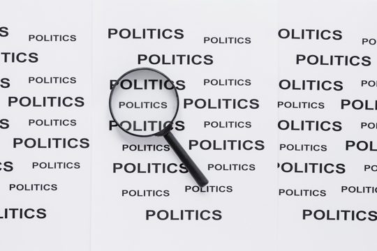 Top view of magnifying glass with politics