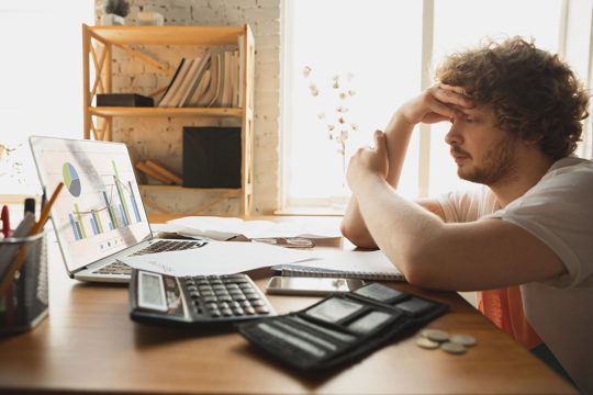 Caucasian upset and despair man watching financial and economical reports