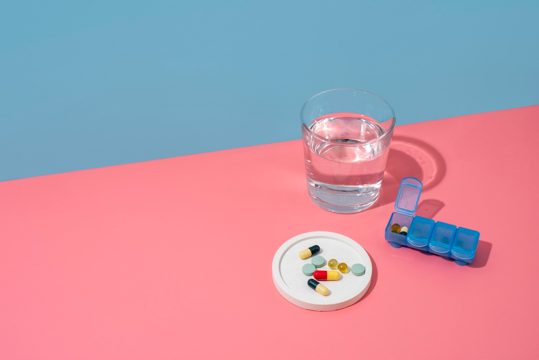 High angle pills container and water glass arrangement