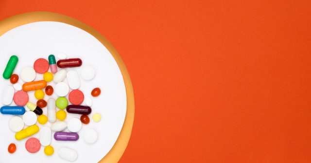 Top view of assortment of pills in circle with copy space