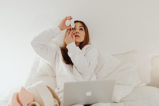 A Woman Using an Eye Drops