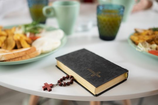 High angle bible and rosary on table